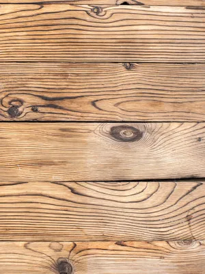 Close up of wide pine and oak floor boards showing grain and knots