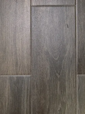Close up of gray luxury vinyl planks with a wood grain texture